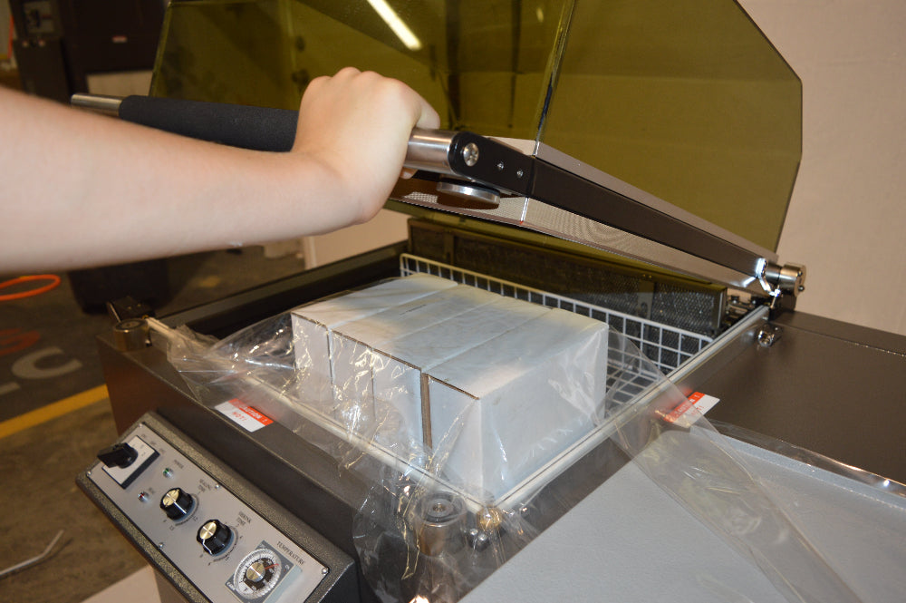 TL-76ST in Use with 4 White boxes in shrink film ready for packaging