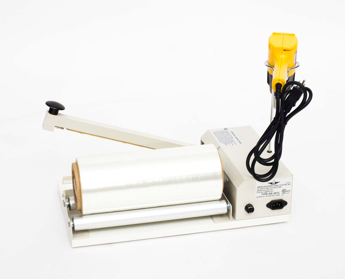 Back of I bar sealer showing plug, film holder, heat gun holder, and fuse