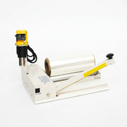 I bar sealer front with film, gun in holder, and sealing bar open
